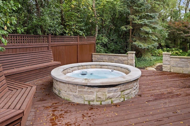 wooden terrace featuring an outdoor hot tub