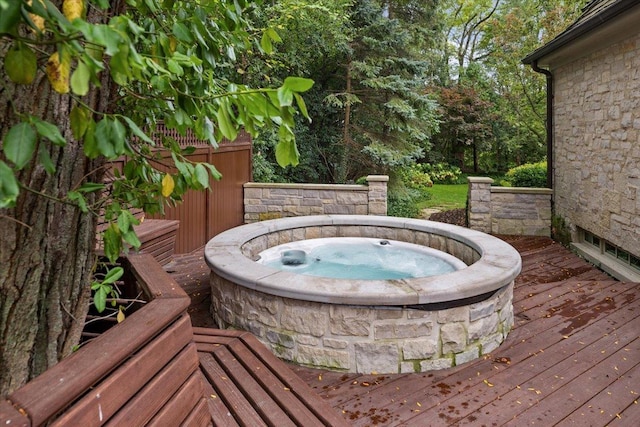 wooden deck featuring an outdoor hot tub