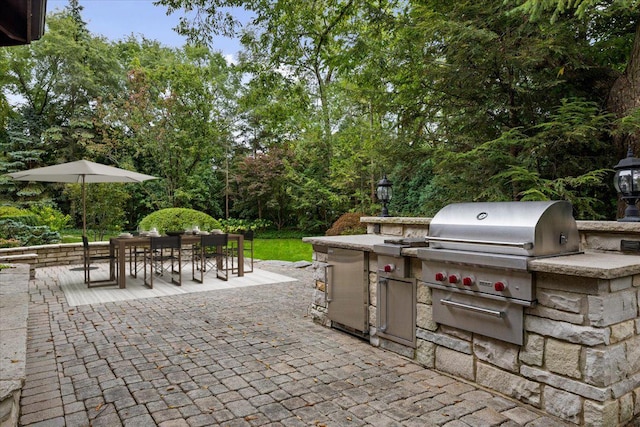 view of patio / terrace featuring area for grilling, outdoor dining area, and a grill