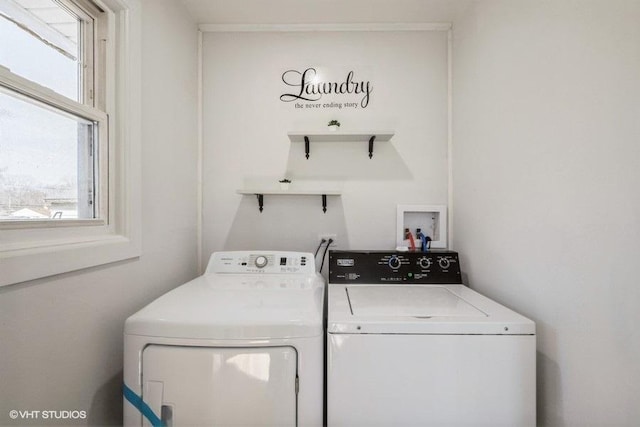 laundry room featuring separate washer and dryer and laundry area