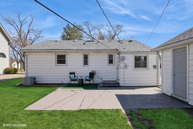 back of house with a patio, cooling unit, a lawn, and a shingled roof