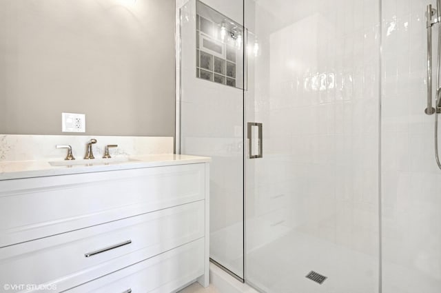 bathroom featuring a stall shower and vanity