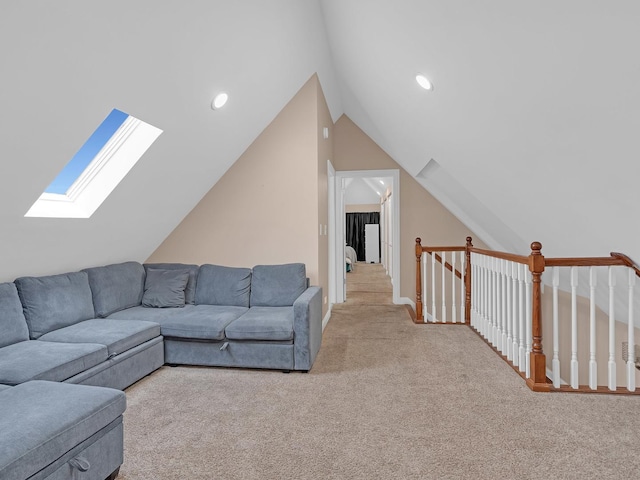 carpeted living room with vaulted ceiling with skylight and recessed lighting