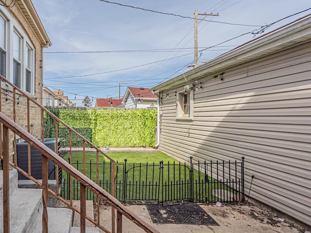 exterior space featuring cooling unit, a lawn, and fence