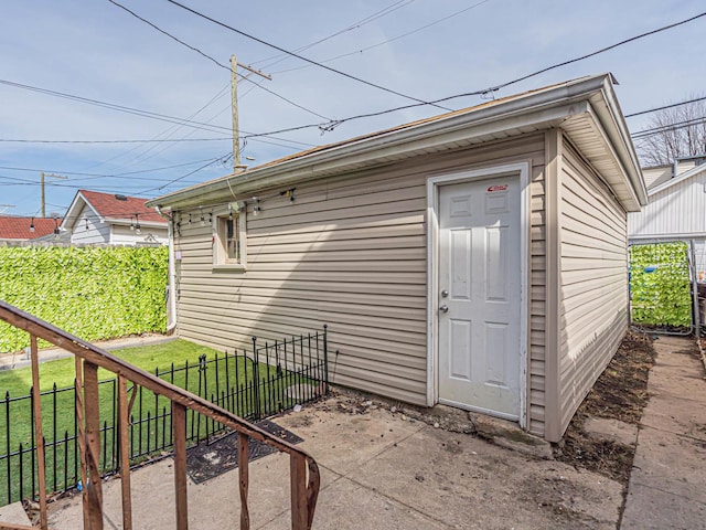 property entrance featuring a lawn and fence