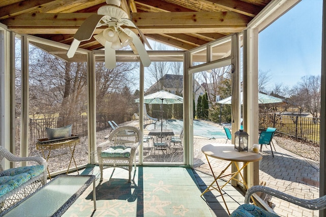 sunroom featuring a ceiling fan