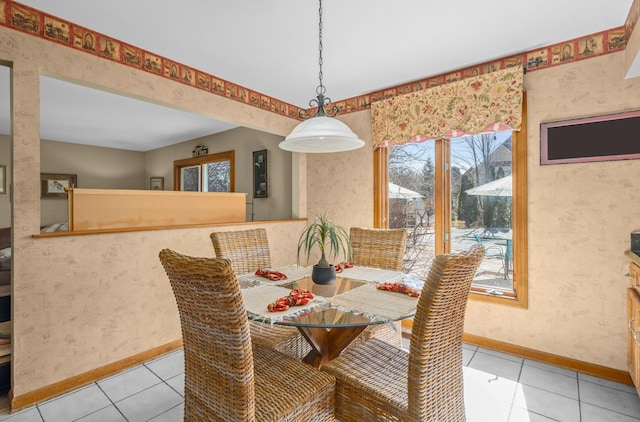 dining room with wallpapered walls, light tile patterned floors, and baseboards