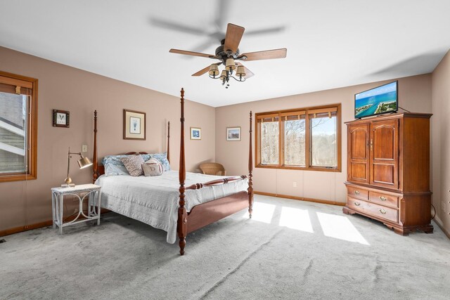 bedroom with baseboards, light carpet, and a ceiling fan