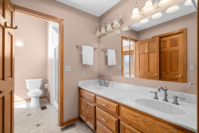 full bathroom with a sink, visible vents, toilet, and double vanity