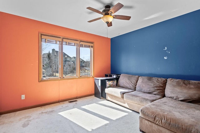 living room featuring visible vents, carpet flooring, baseboards, and ceiling fan