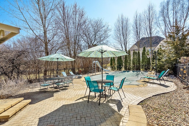 view of patio featuring fence and a fenced in pool