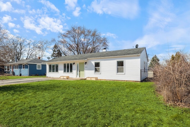 single story home featuring aphalt driveway and a front lawn