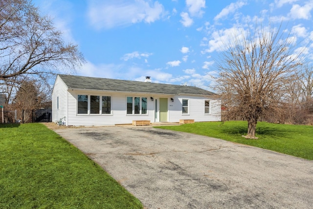 single story home featuring aphalt driveway, a front yard, and fence