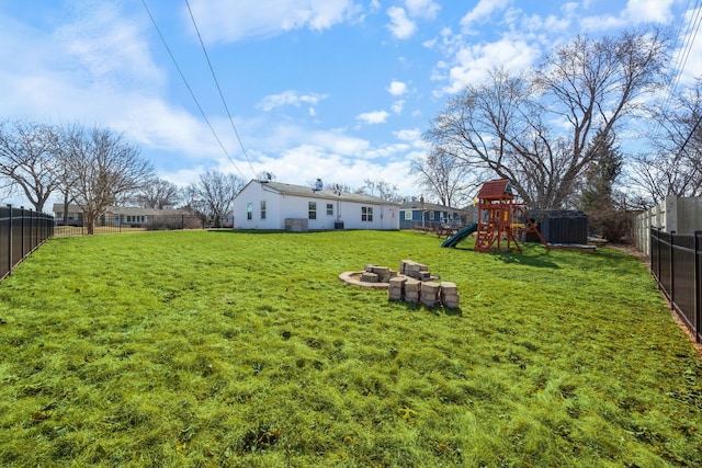 view of yard featuring a fenced backyard and a playground