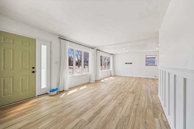 foyer entrance with light wood finished floors