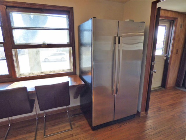 kitchen featuring wood-type flooring and freestanding refrigerator