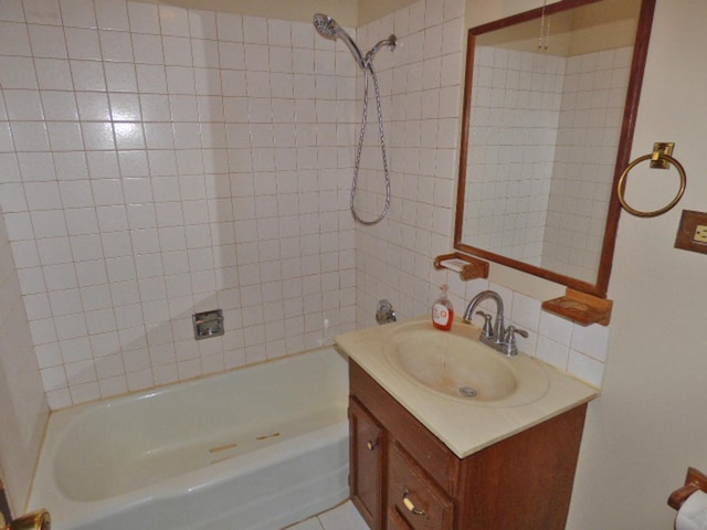 bathroom featuring bathtub / shower combination and vanity