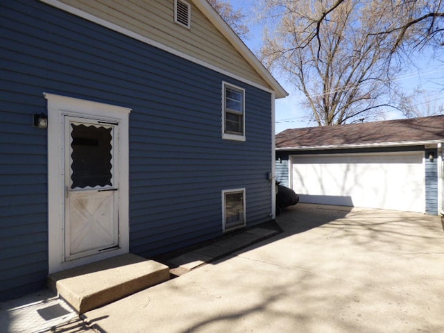 view of property exterior with an outbuilding and a garage