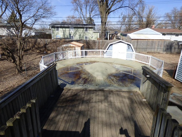 view of swimming pool with a deck and a fenced backyard