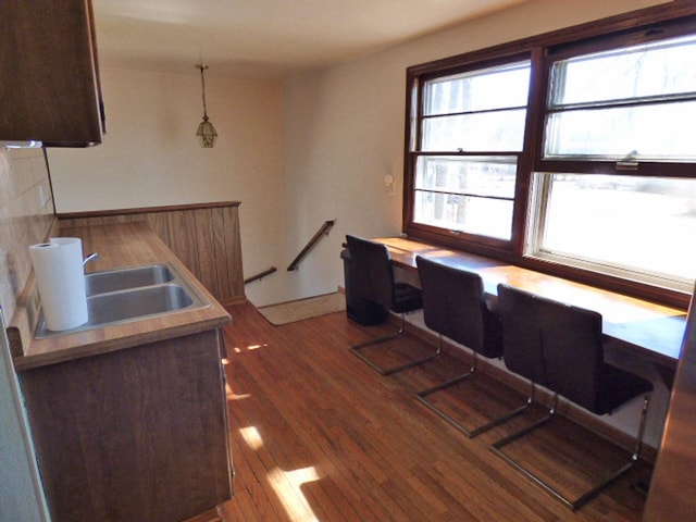 office area with a sink and wood finished floors