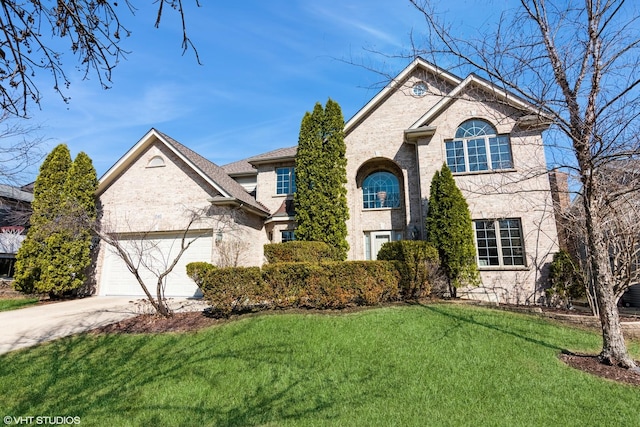 view of front of home featuring a front lawn, an attached garage, and driveway