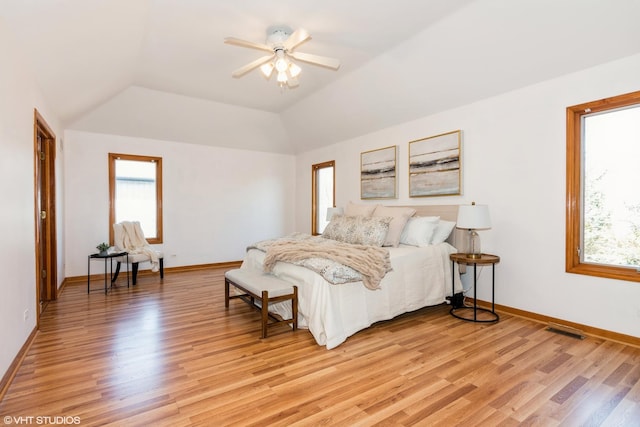 bedroom with visible vents, baseboards, light wood-type flooring, and lofted ceiling