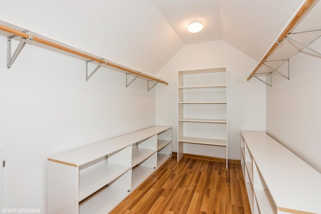 spacious closet featuring vaulted ceiling and light wood finished floors