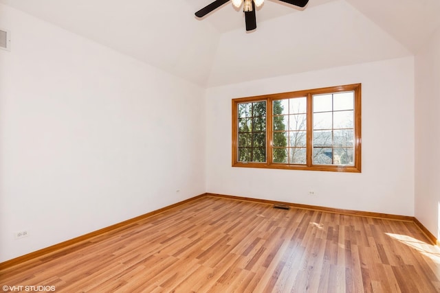 unfurnished room featuring visible vents, a ceiling fan, light wood finished floors, baseboards, and vaulted ceiling