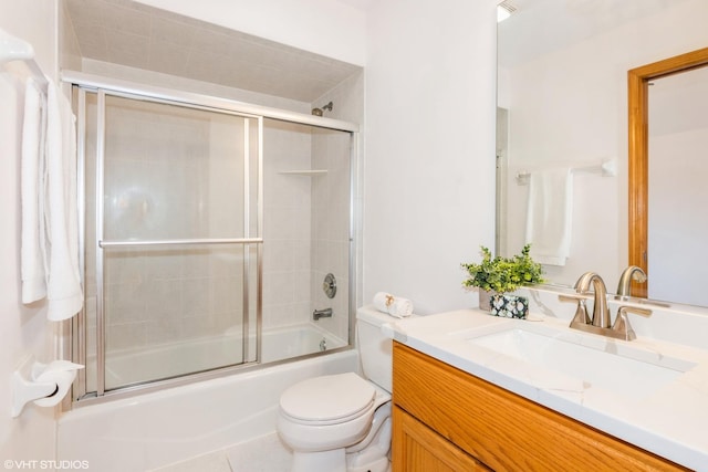 full bathroom with vanity, tile patterned floors, toilet, and combined bath / shower with glass door