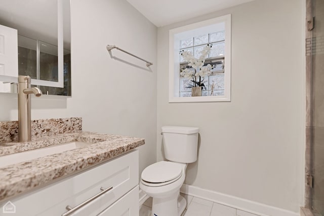 full bath featuring baseboards, toilet, vanity, and tile patterned flooring