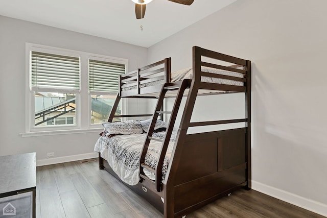 bedroom with ceiling fan, baseboards, and wood finished floors