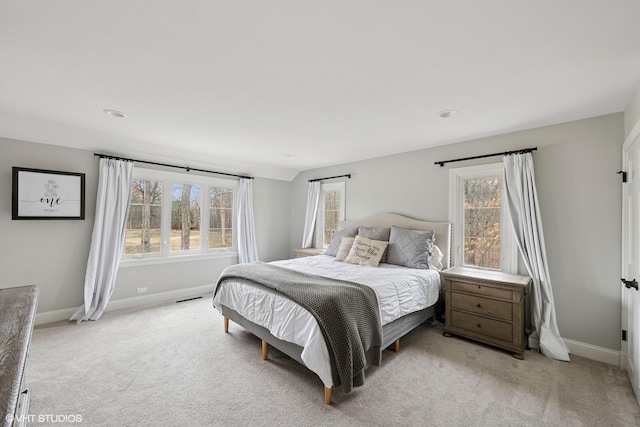 bedroom with light carpet, visible vents, and baseboards