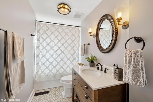 bathroom featuring toilet, vanity, tile patterned flooring, and visible vents