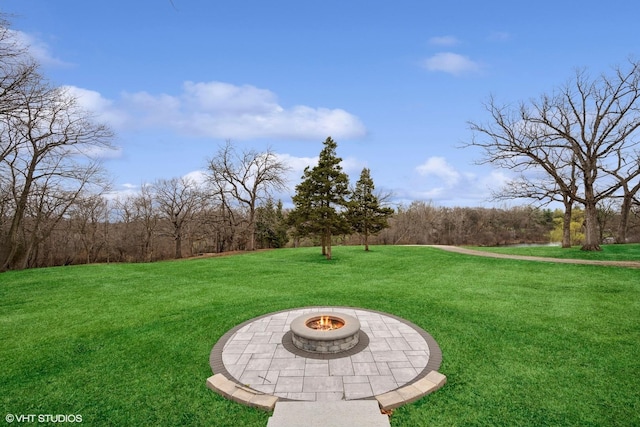 view of yard with a fire pit