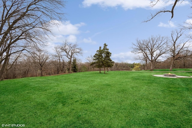 view of yard with a fire pit