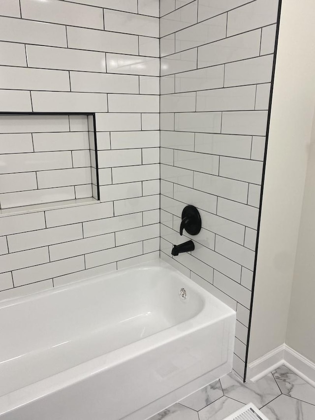 full bathroom featuring shower / bathing tub combination, baseboards, and marble finish floor