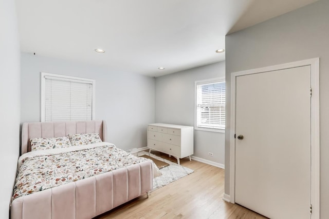 bedroom with recessed lighting, light wood-type flooring, and baseboards