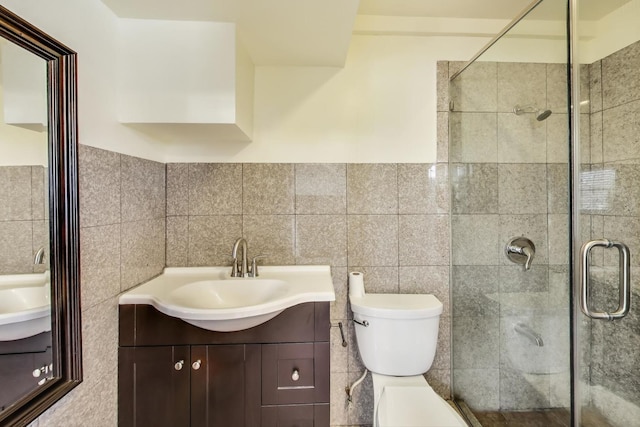 full bathroom featuring toilet, a stall shower, and vanity