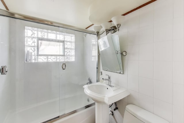 full bath featuring tile walls, toilet, and enclosed tub / shower combo