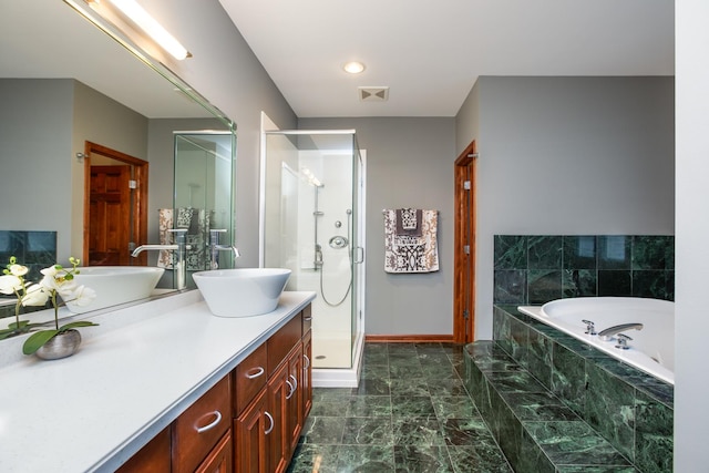 full bath with visible vents, baseboards, a stall shower, a bath, and vanity