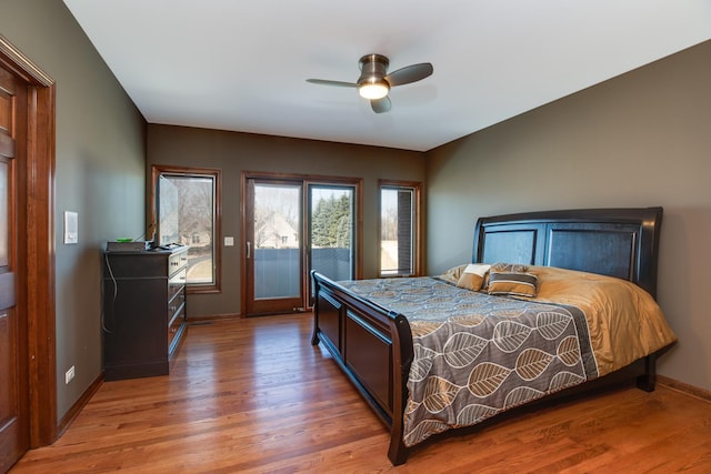 bedroom with light wood finished floors, ceiling fan, baseboards, and access to exterior