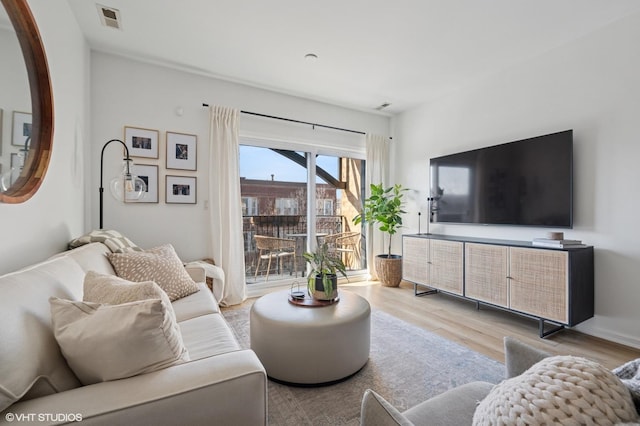 living room featuring wood finished floors and visible vents