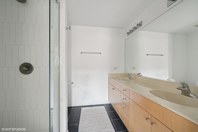 full bath with tile patterned flooring, a tile shower, and a sink