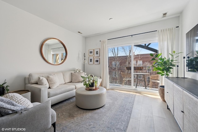 living room featuring wood finished floors and visible vents