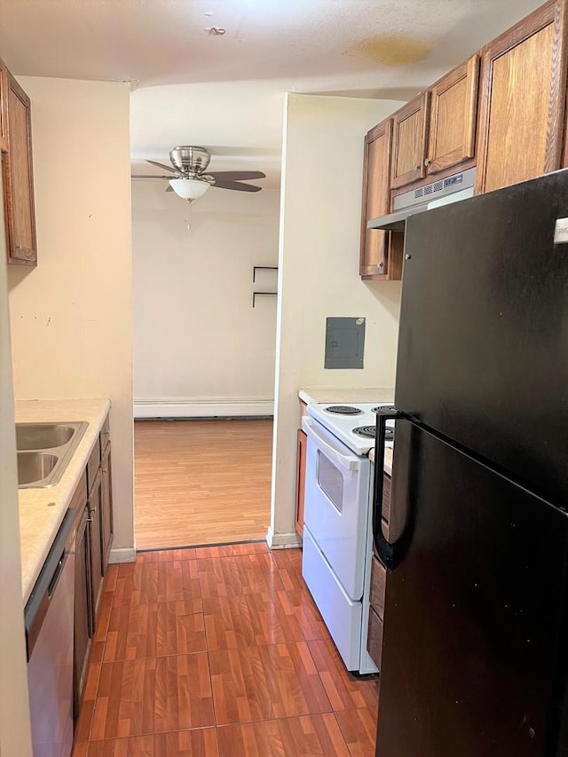 kitchen with a sink, stainless steel dishwasher, dark wood-style floors, white electric range oven, and freestanding refrigerator