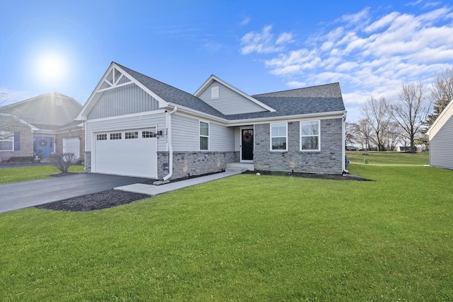 view of front of house with aphalt driveway, a garage, a front lawn, and a shingled roof