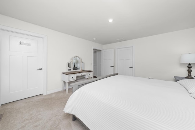 bedroom featuring light colored carpet and baseboards