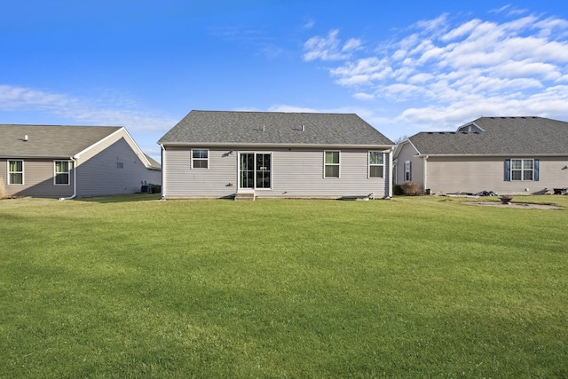 back of house with a lawn