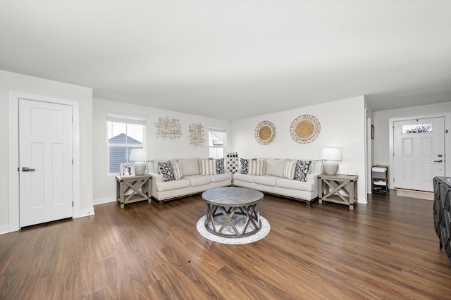 living area with dark wood-style floors and baseboards