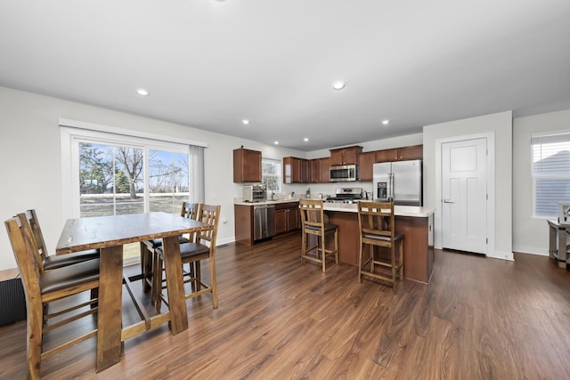 dining room featuring dark wood finished floors, plenty of natural light, recessed lighting, and baseboards